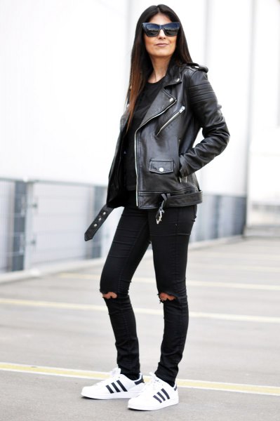 black leather biker jacket with knee-ripped slim fit jeans