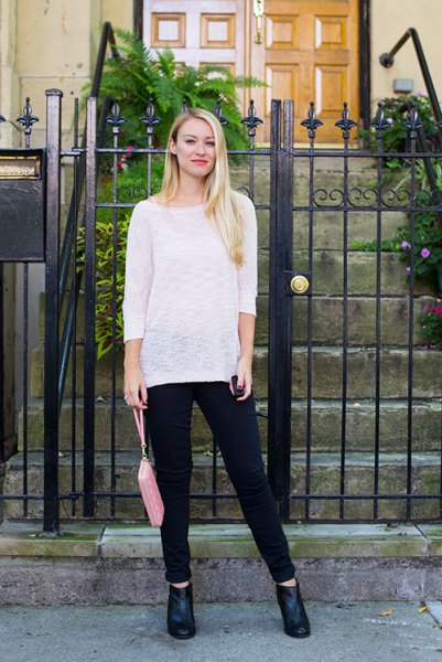 white, semi-transparent slouchy sweater with a boat neckline and black jeans