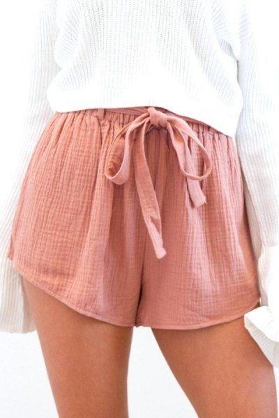 white, ribbed, oversized knit sweater with pink tie-mini chiffon shorts with elastic waist at the front