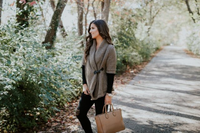 gray half-sleeved sweater with black long-sleeved shirt and brown leather pocket