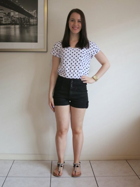 white and black short-sleeved t-shirt with polka dots and mini denim shorts