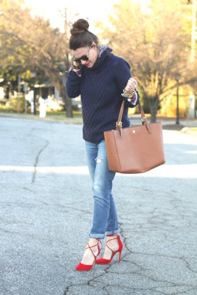 black knit sweater with blue jeans with cuffs and red heels