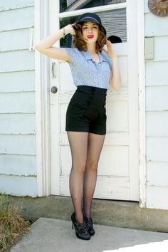 blue short-sleeved button-up shirt and black high-waisted vintage shorts