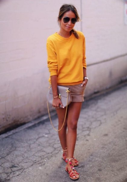 bright lemon yellow sweater with pink shorts and silver summer sandals