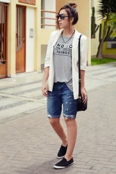 white casual blazer with gray graphic t-shirt and denim shorts