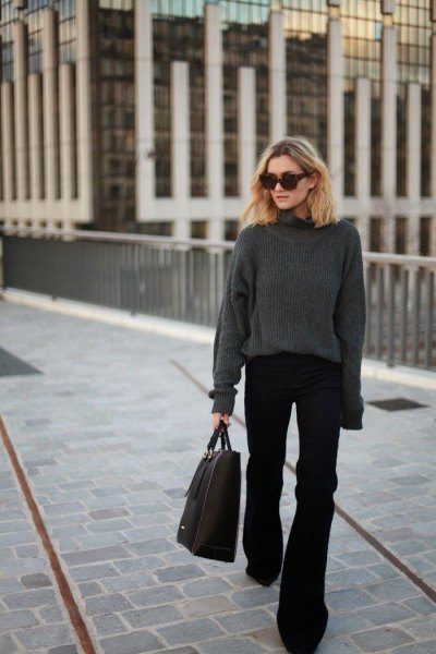 gray, thick sweater with a round neckline and black flared jeans