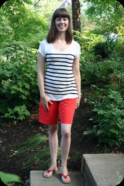 white and black striped t-shirt with scoop neck, shorts and slide sandals