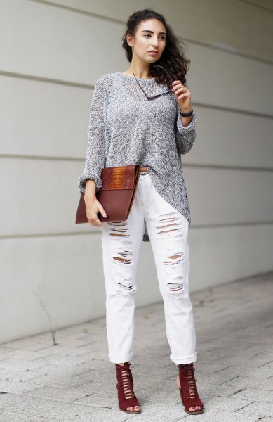 gray sweater with torn white boyfriend jeans with cuffs