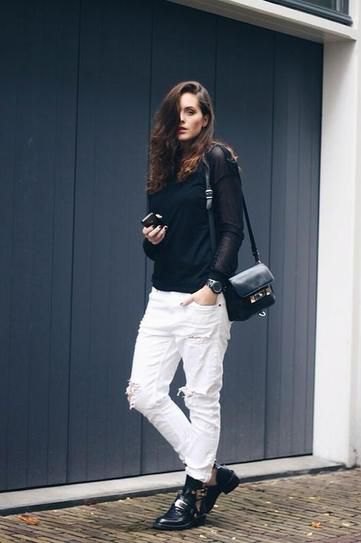 black sweater with stand-up collar and white boyfriend jeans