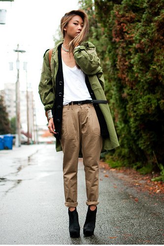 green longline military jacket with white tank top and chinos with cuffs
