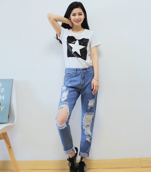 white graphic t-shirt with light blue torn boyfriend jeans