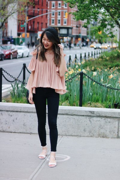 pale pink pleated chiffon blouse with cold shoulder and black jeans