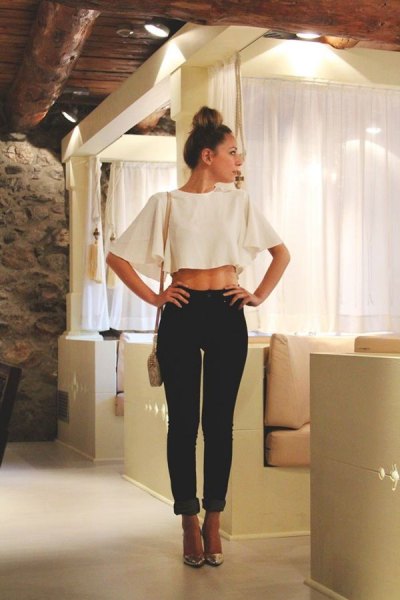 white bat top with black slim fit jeans with cuff