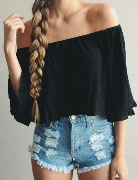 Black off shoulder shirt with half sleeves and blue shorts with a mini denim tear
