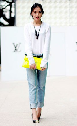 white long-sleeved t-shirt with light blue cuffed jeans and yellow clutch