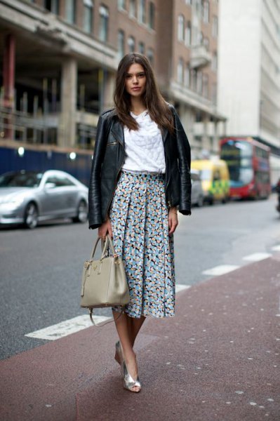 black leather jacket with white blouse and floral pleated skirt