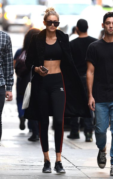 black bomber jacket with crop top and sports gaiters