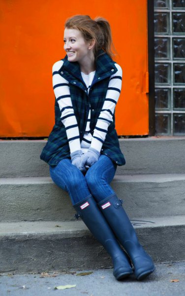 black and white striped long-sleeved sweater with dark blue checked vest