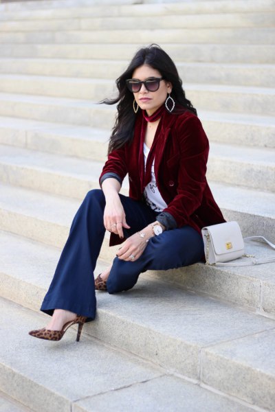 brown jacket with white t-shirt with a scoop neck and flared navy pants