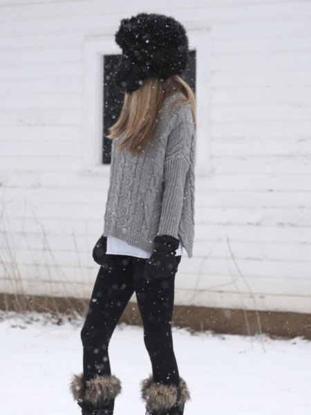 gray, coarse-grain knit sweater with knee-high boots made of faux fur
