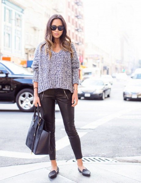 gray, chunky sweater with V-neck and leather leggings and loafers