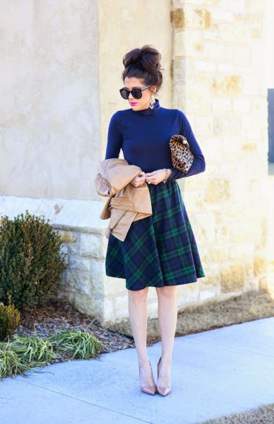 blue mock neck sweater with knee-length plaid skirt