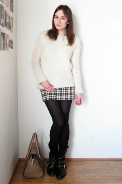 white fuzzy sweater with mini plaid skirt made of wool and stockings
