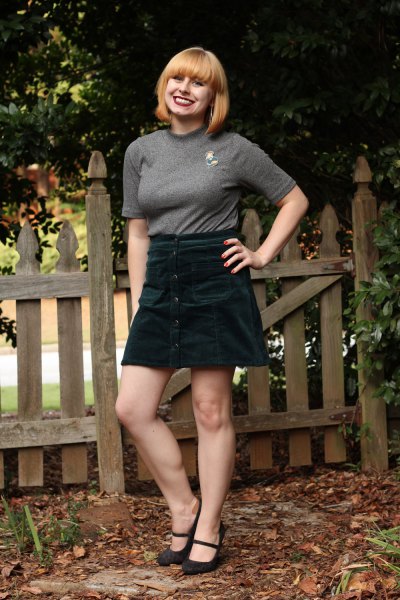 gray, form-fitting t-shirt with half sleeves and black mini skirt
