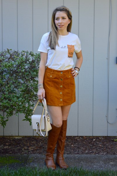 white printed t-shirt with green cord skirt and brown boots