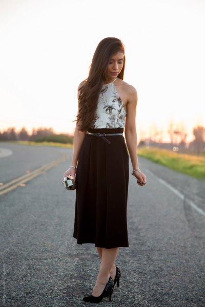 white halter top with floral pattern and black midi high skirt