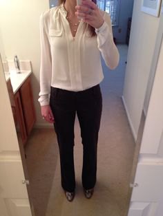cream-colored blouse with black chinos and leather ankle boots