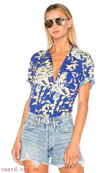 royal blue and white hiking shirt with floral print and denim shorts