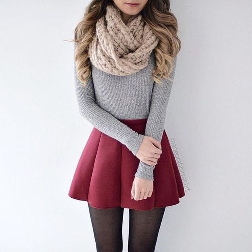 Cable knit scarf with a figure-hugging gray sweater and maroon pleated mini skirt