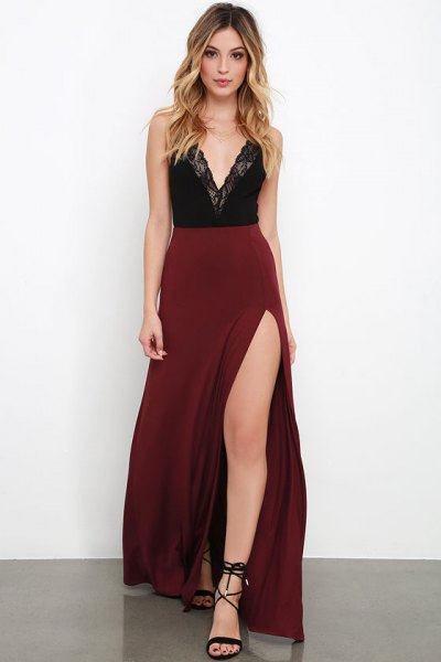 Top with deep V-neck made of black lace and high waisted, maroon maxi skirt