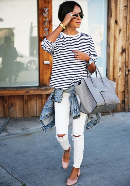 black and white striped long-sleeved t-shirt with a round neckline and torn slim fit jeans