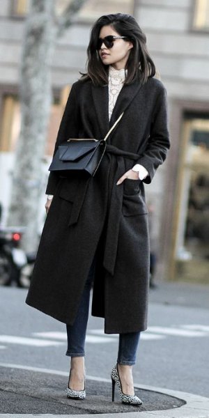 black woolen coat with gray knitted sweater with stand-up collar and ankle jeans