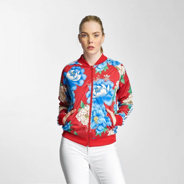 Sports jacket with red and blue floral print and white jeans