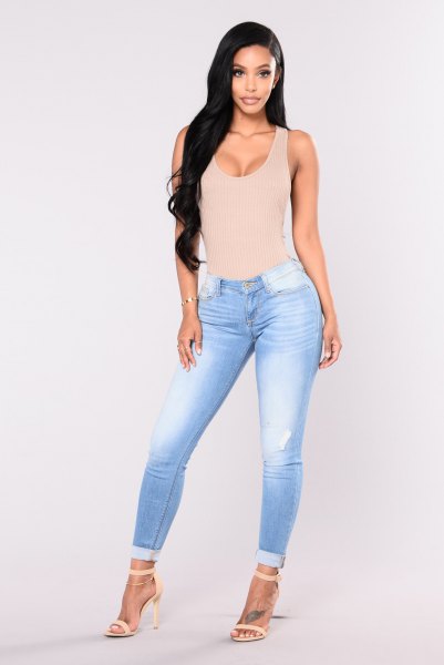 light pink low cut tank top with sky blue low skinny jeans