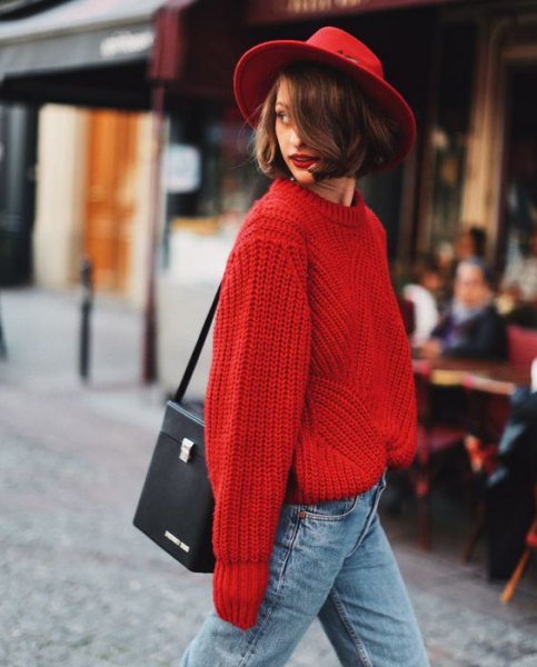 red felt hat with chunky red sweater with light blue jeans