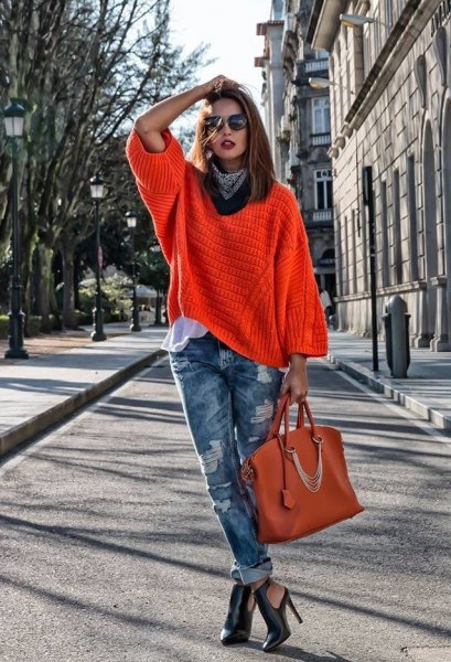 red wide neck warm sweater with ripped jeans