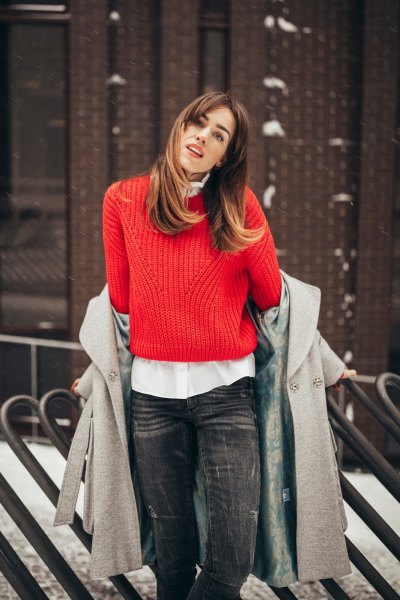 red ribbed sweater with white button shirt and gray wool coat
