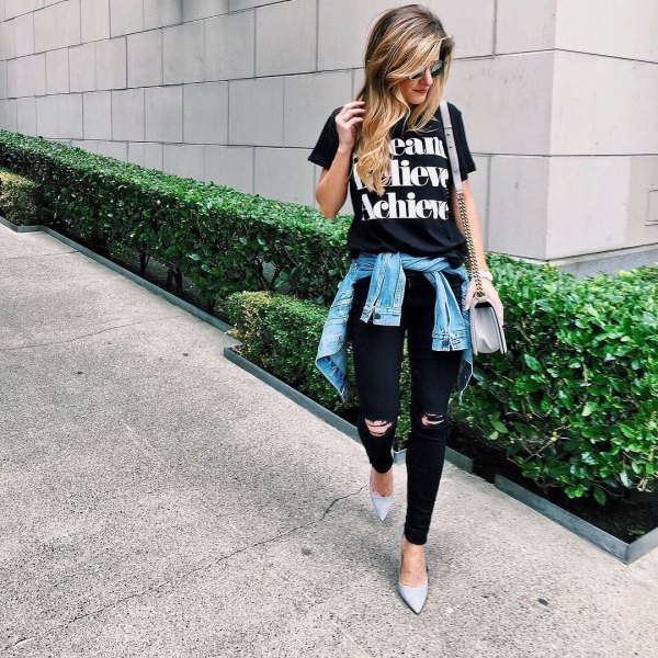 black print tee with ripped jeans and denim jacket tied around the waist