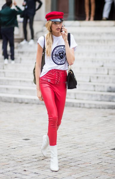 white cool graphic tee with red paint hat and matching leather clothes