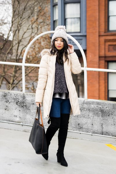 white long down coat with heather gray sweater and high thigh boots