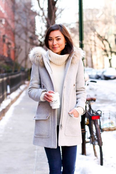 light gray long winter coat with white sweater in ribbed sweater