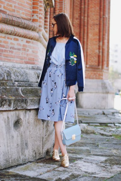 blue embroidered bomber jacket with light blue midi graphic skirt