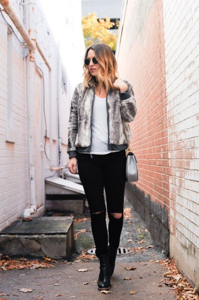 light gray fitted fur bomber jacket with black ripped slim fit jeans