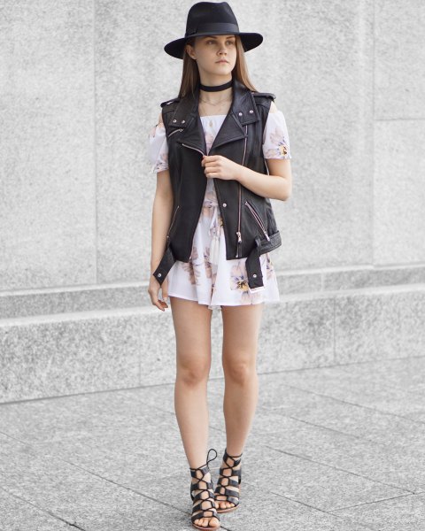 black felt hat with moto-vest and white from the shoulder mini-chiffon dress