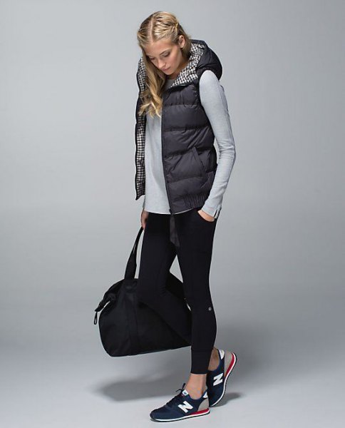black hooded puffer vest with gray fitted long sleeve tee and cropped skinny jeans