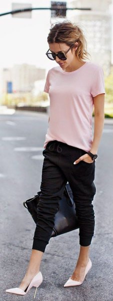 light pink t-shirt with black cropped joggers and white high heels